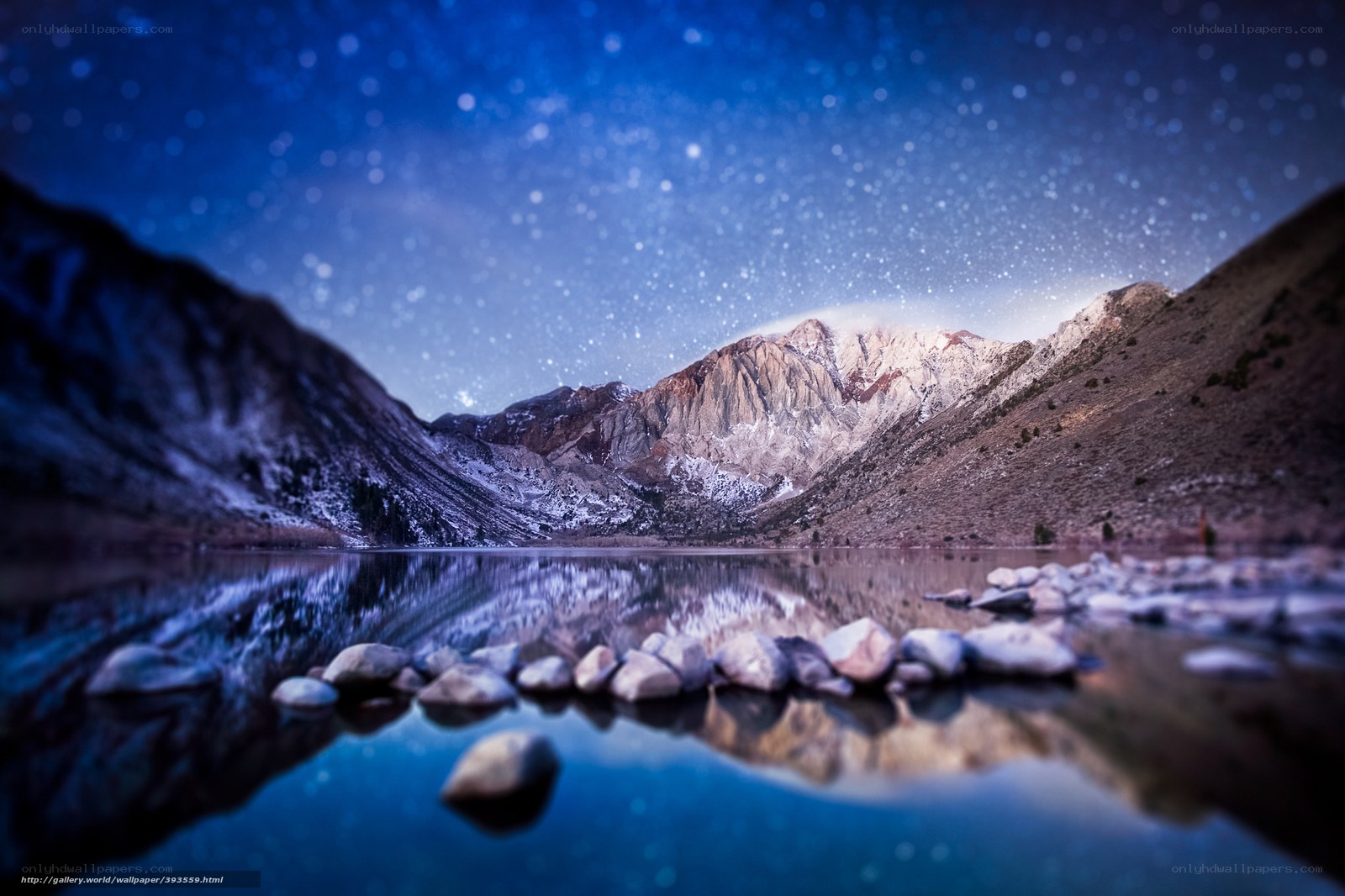 Starry night over mountain lake