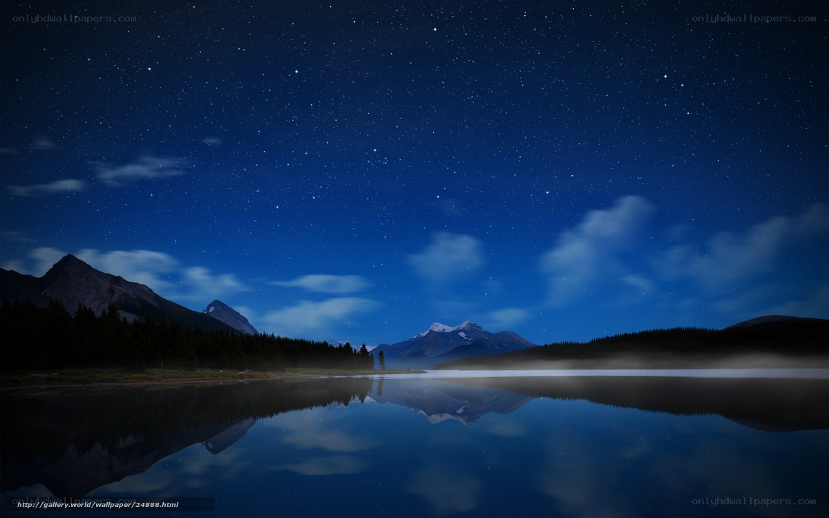 Starry night over mountain lake