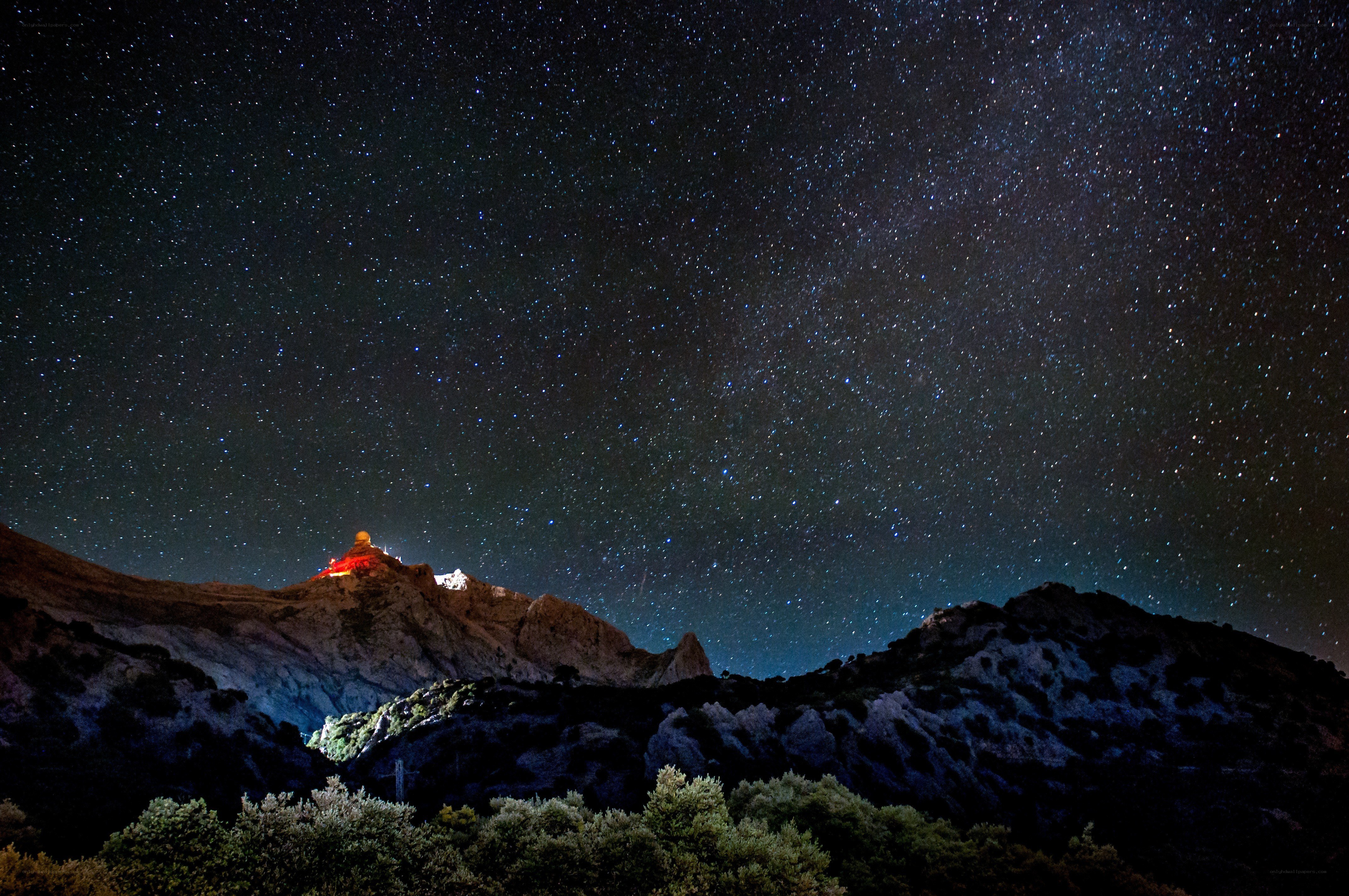 Starry night over mountain observatory