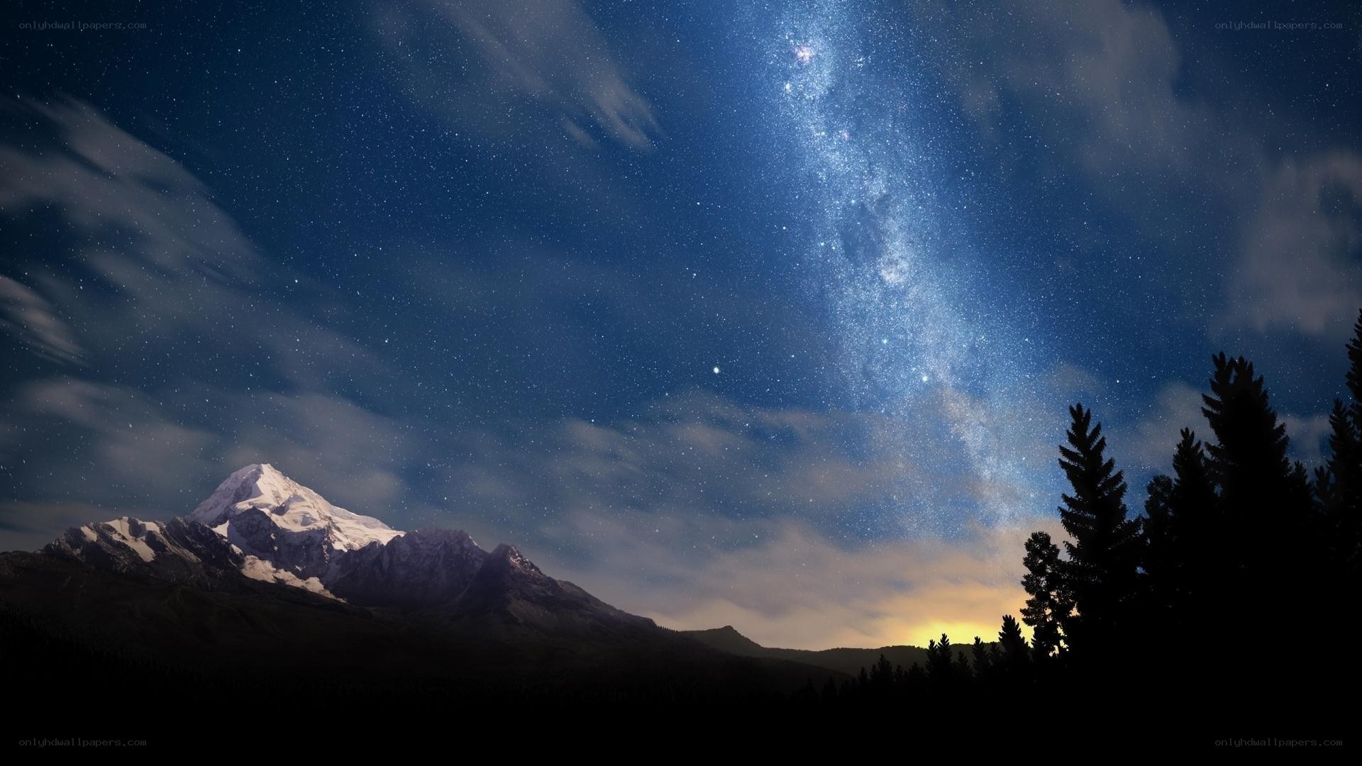 Starry night over mountain peak