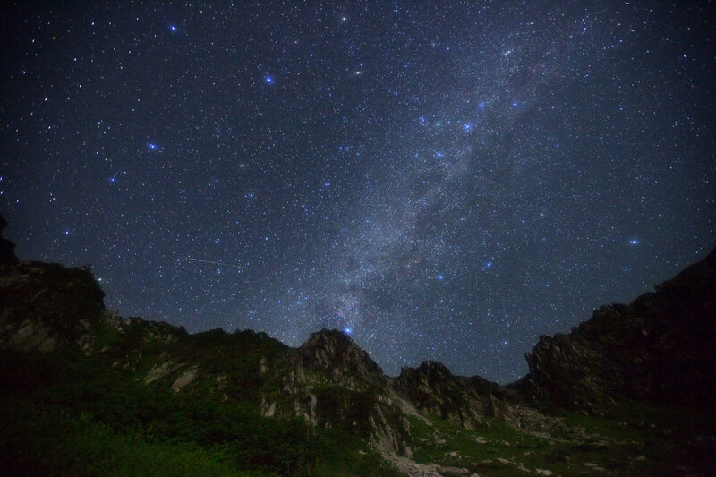 Starry night over mountain peaks