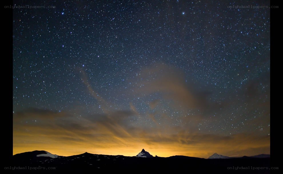 Starry night over mountain peaks