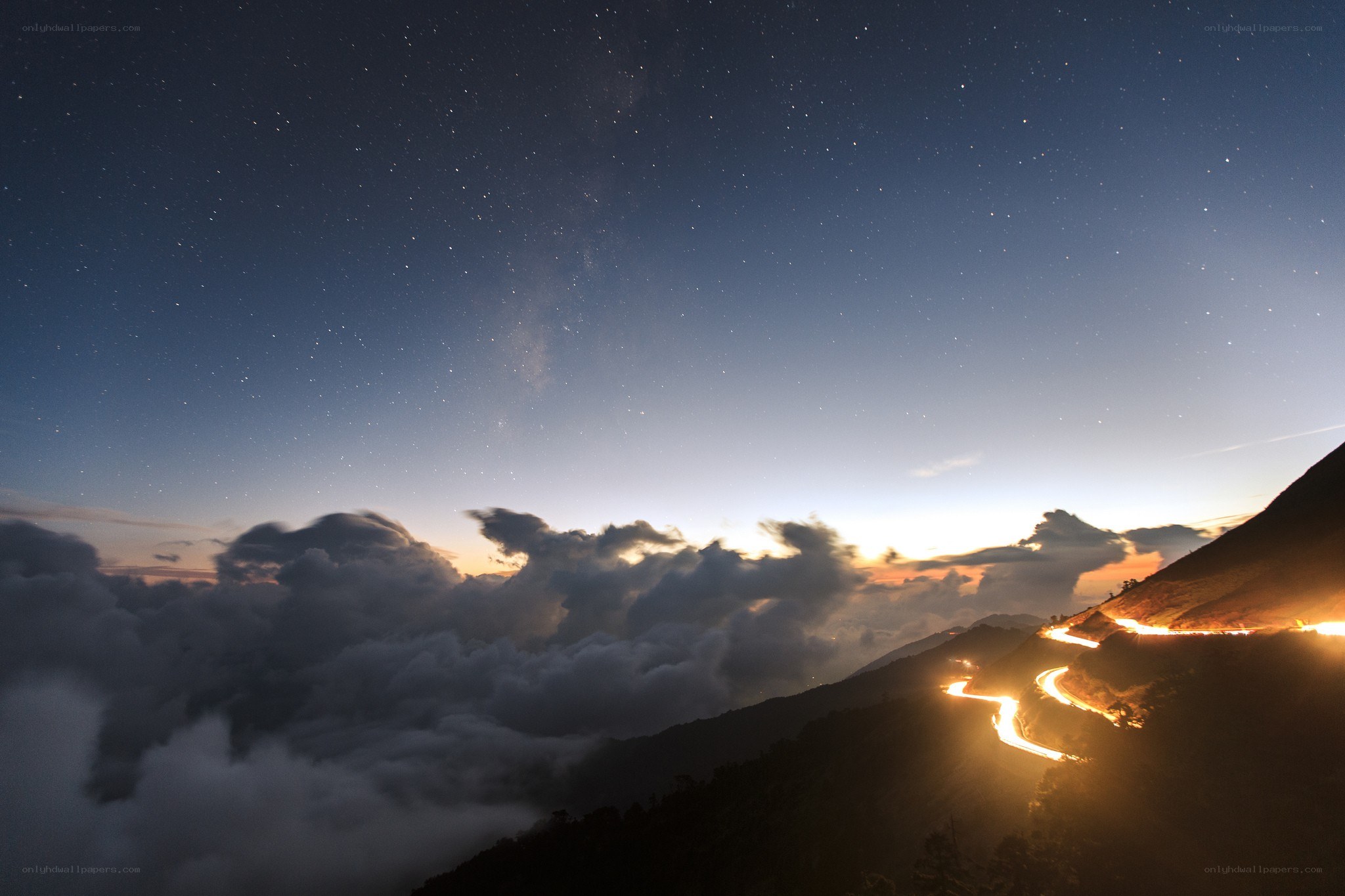 Starry night over mountain road