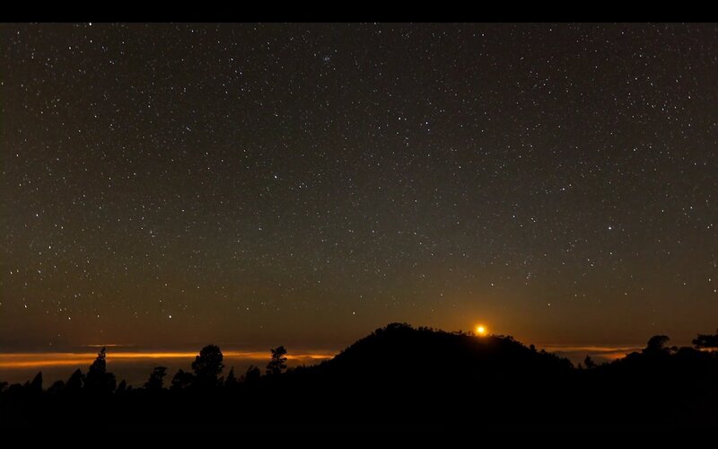 Starry night over mountain silhouette