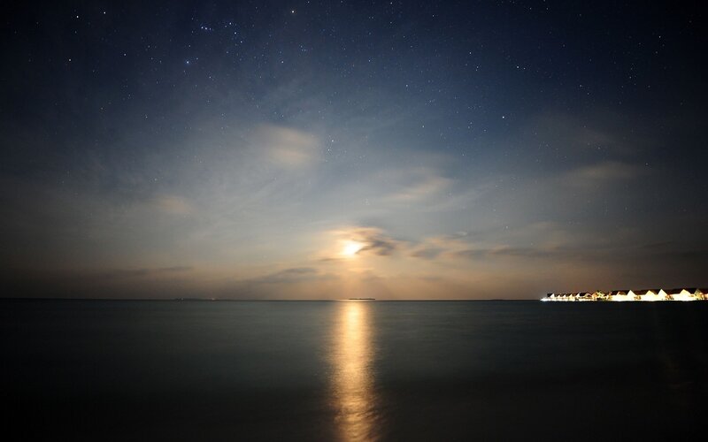 Starry night over ocean resort