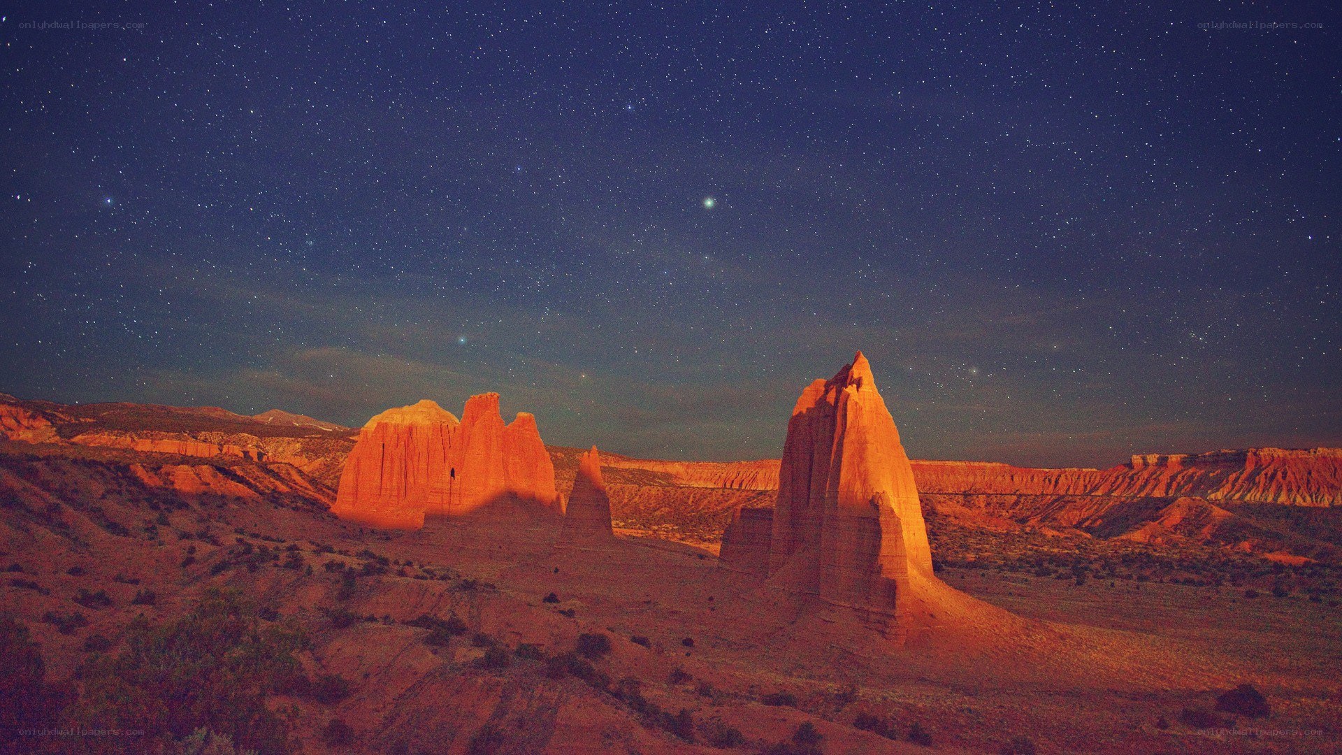 Starry night over red rock formations