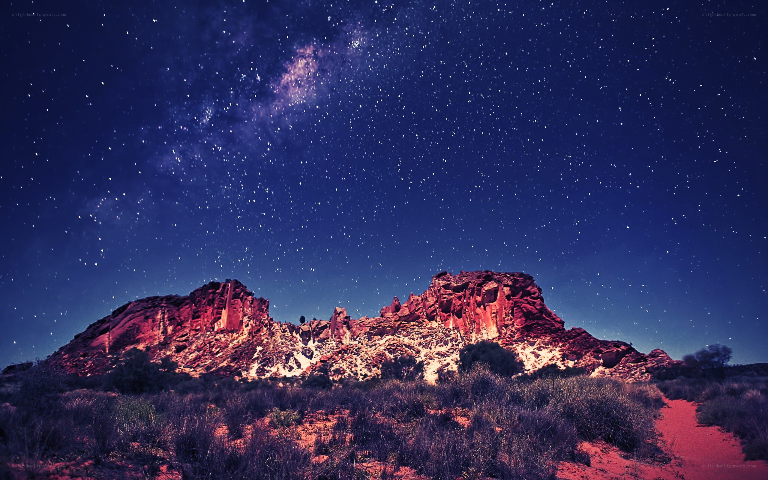 Starry night over red rock formations