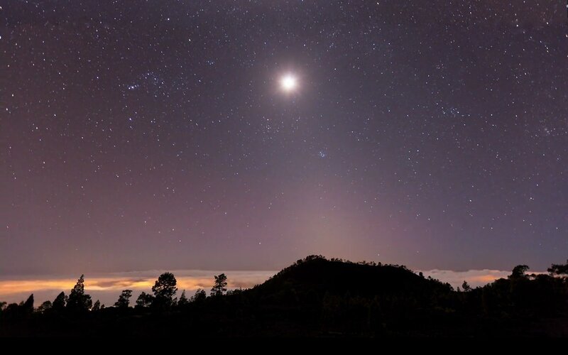 Starry night over silhouetted hills