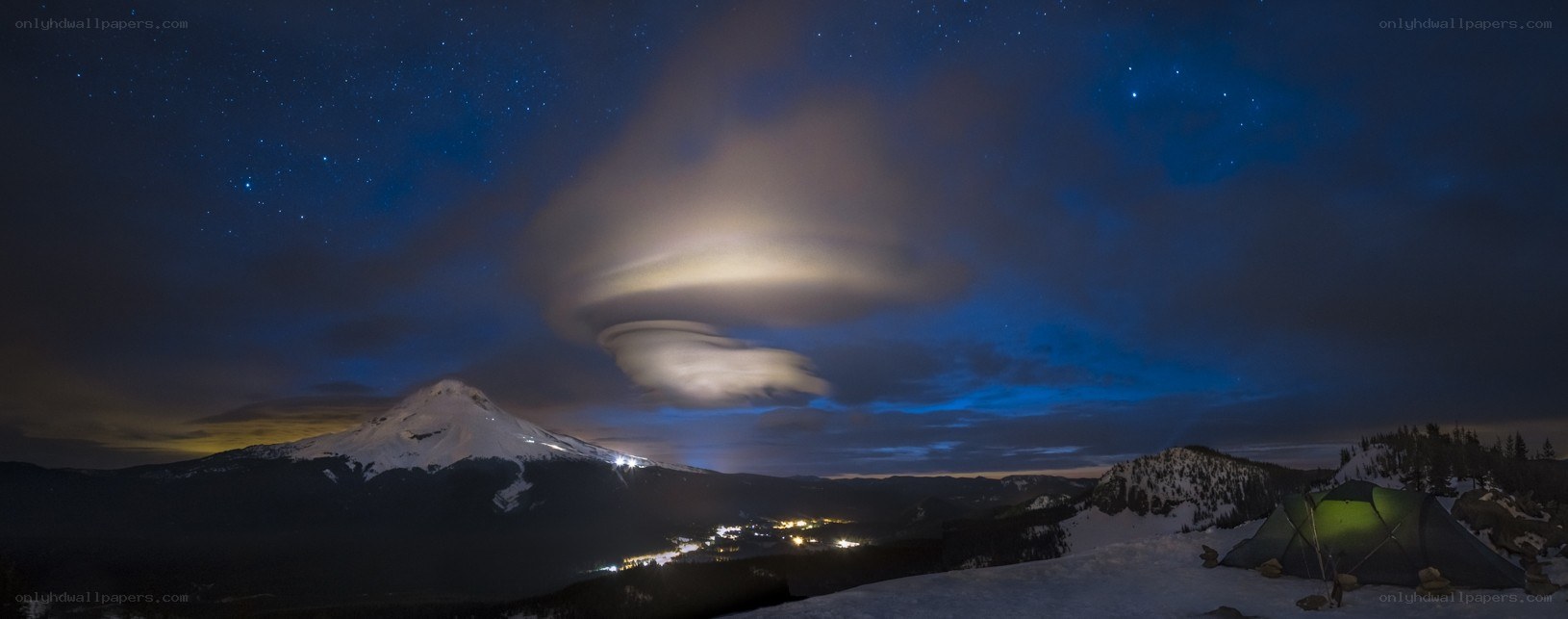 Starry night over snow-capped mountain