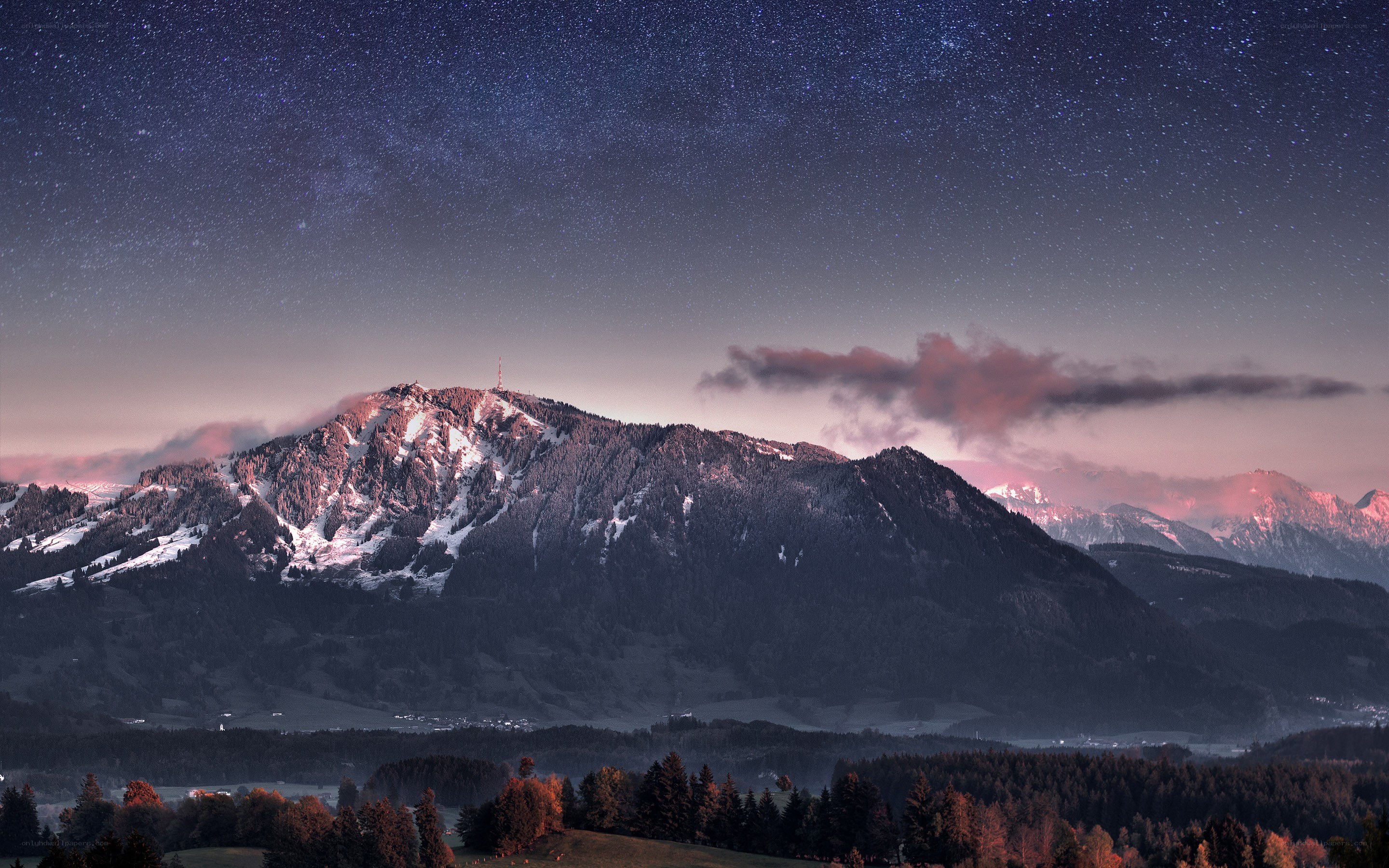 Starry night over snow-capped mountains