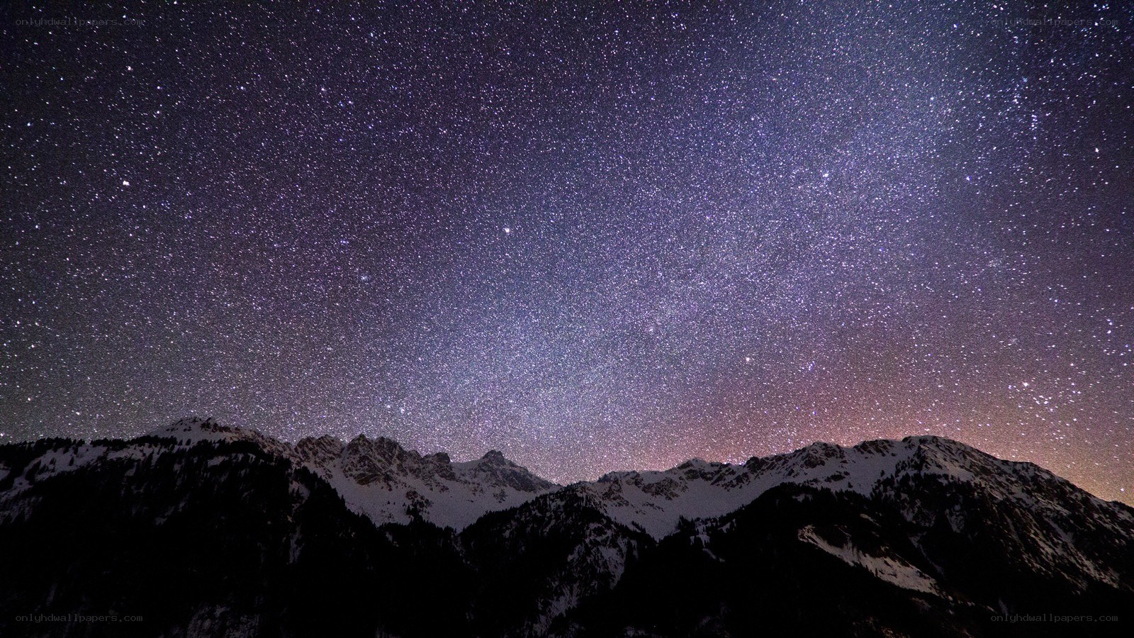 Starry night over snow-capped mountains