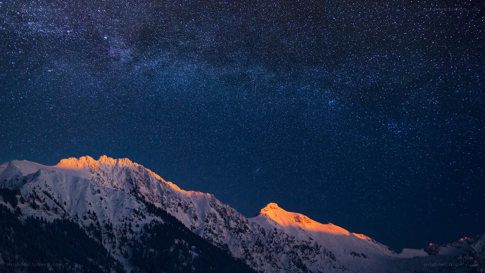 Starry night over snow-capped mountains