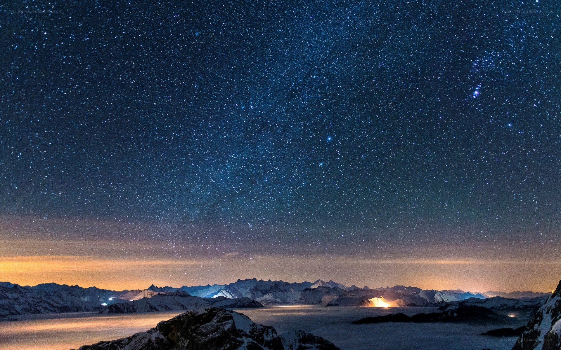 Starry night over snow-capped mountains