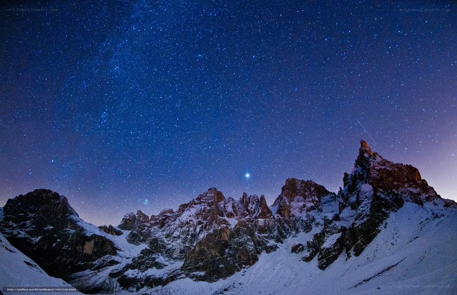 Starry night over snow-capped mountains