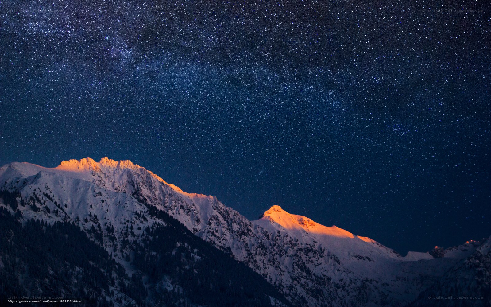 Starry night over snow-capped mountains
