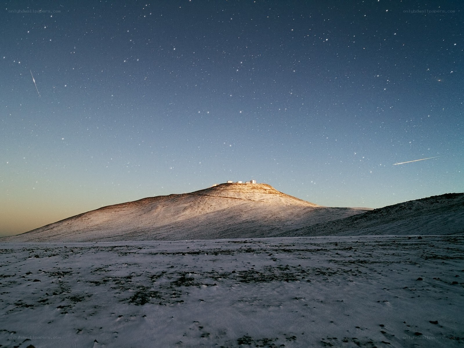 Starry night over snowy mountain
