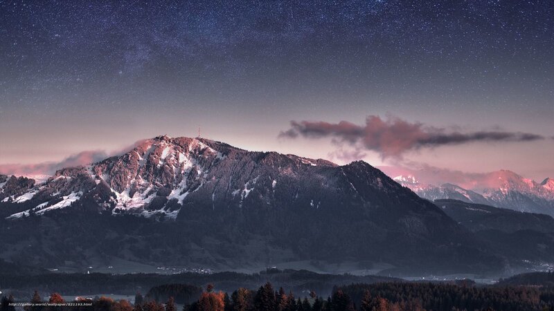 Starry night over snowy mountains