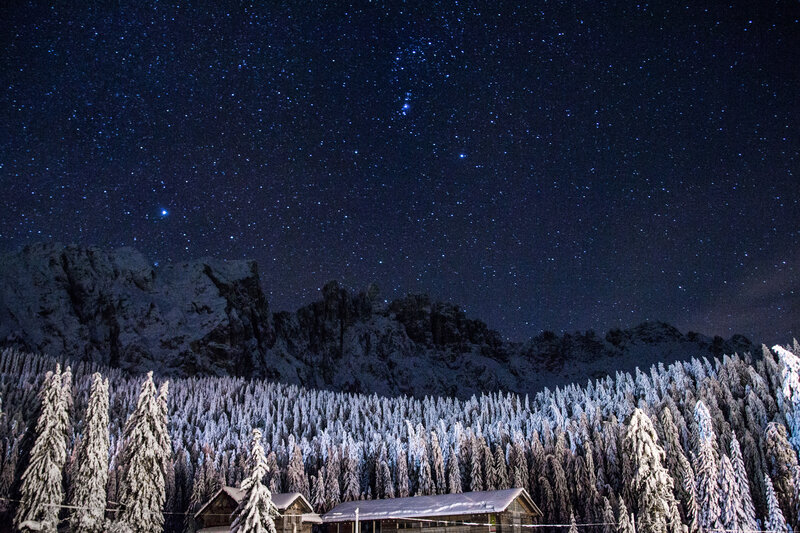 Starry night over snowy mountains