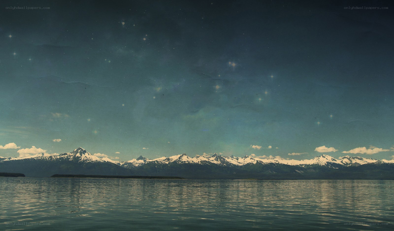 Starry night over snowy mountains