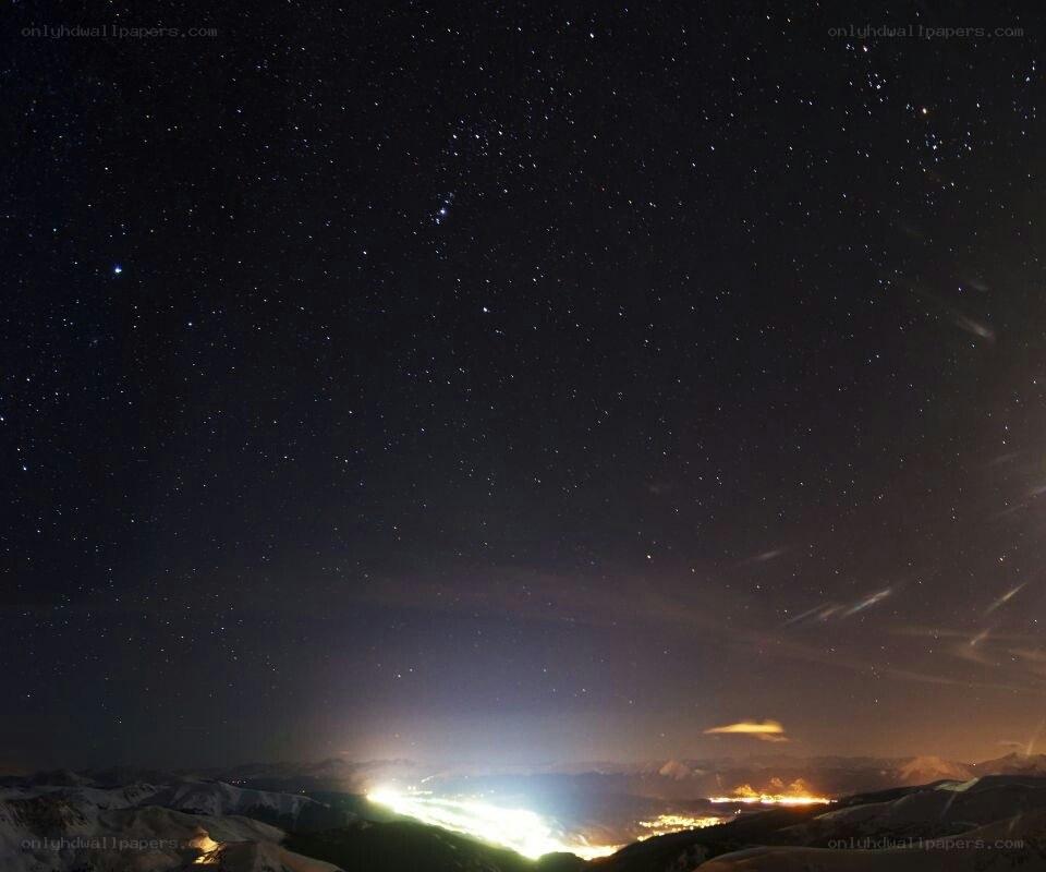 Starry night over snowy mountains