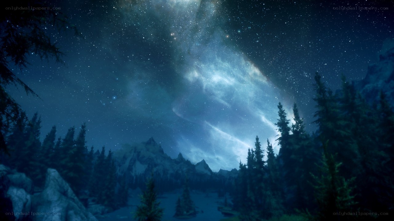 Starry night over snowy mountains