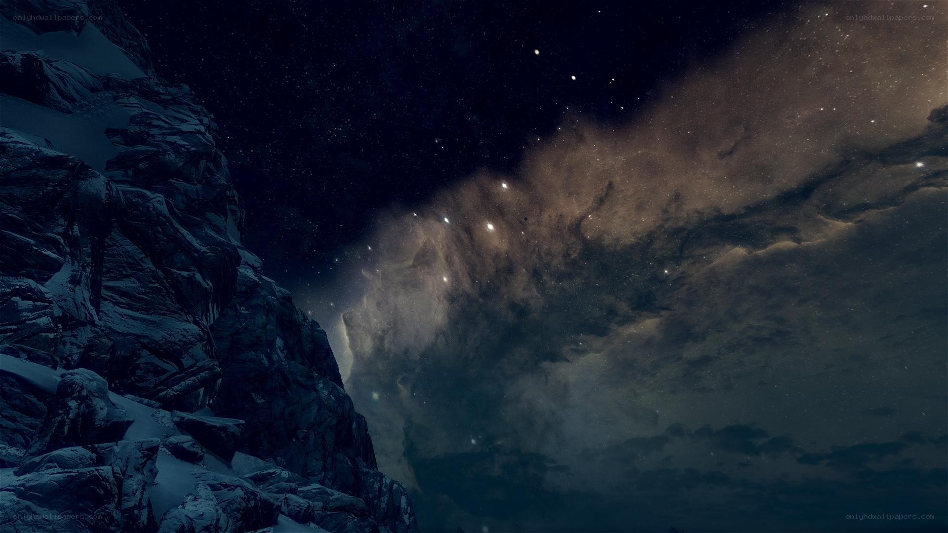 Starry night over snowy mountains