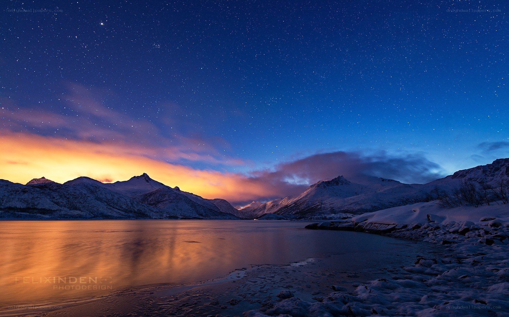 Starry night over snowy mountains