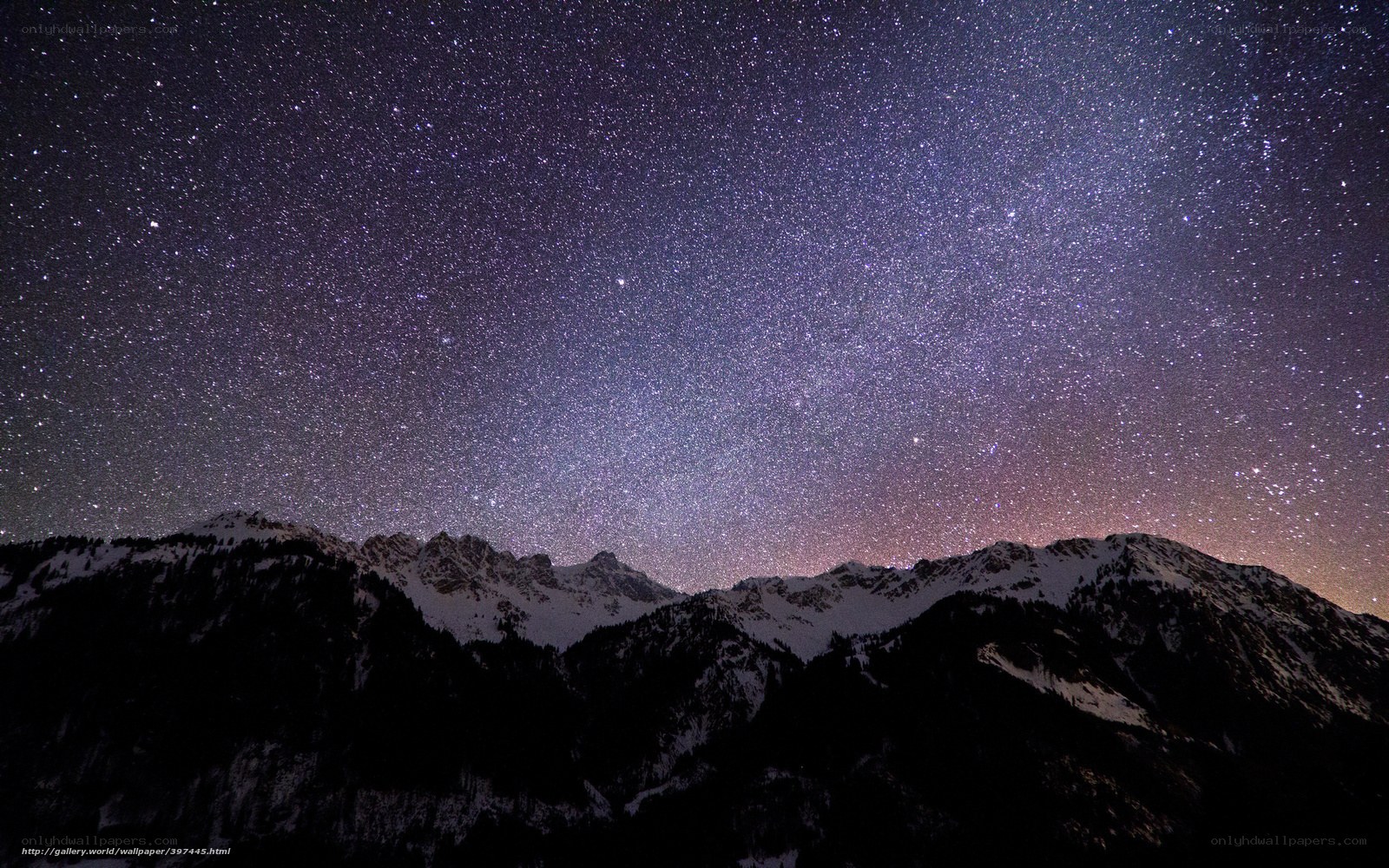 Starry night over snowy mountains