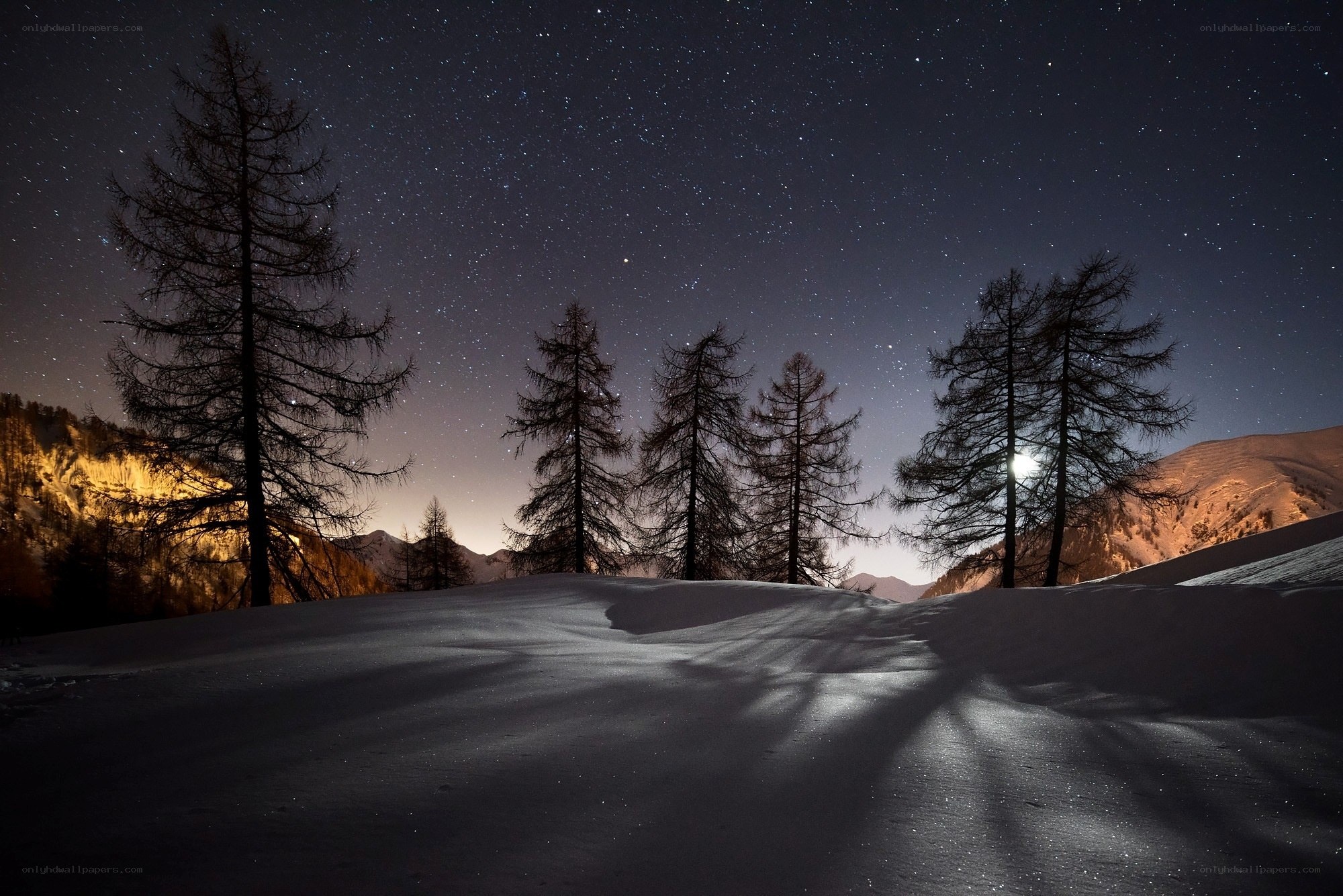 Starry night over snowy mountains