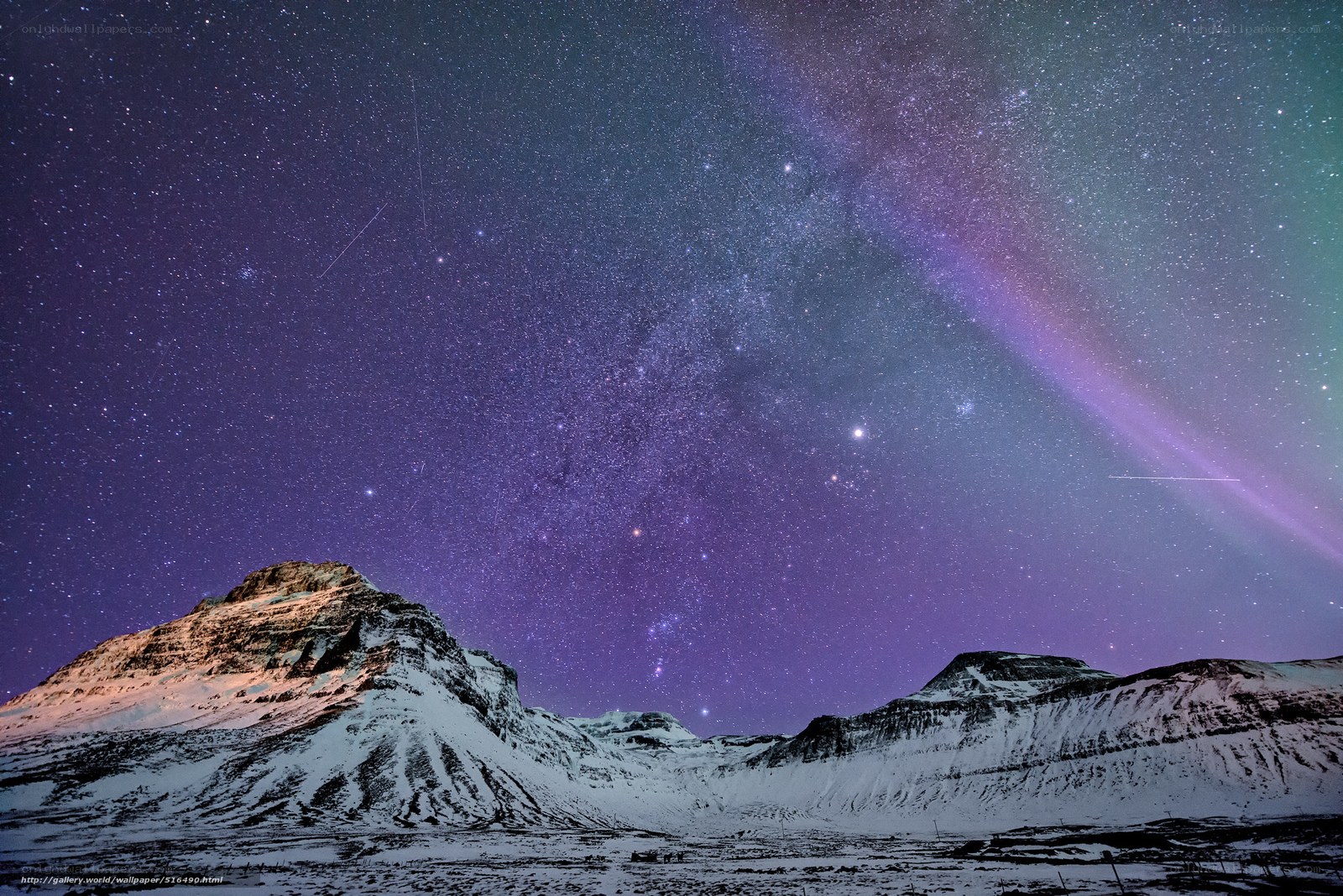Starry night over snowy mountains