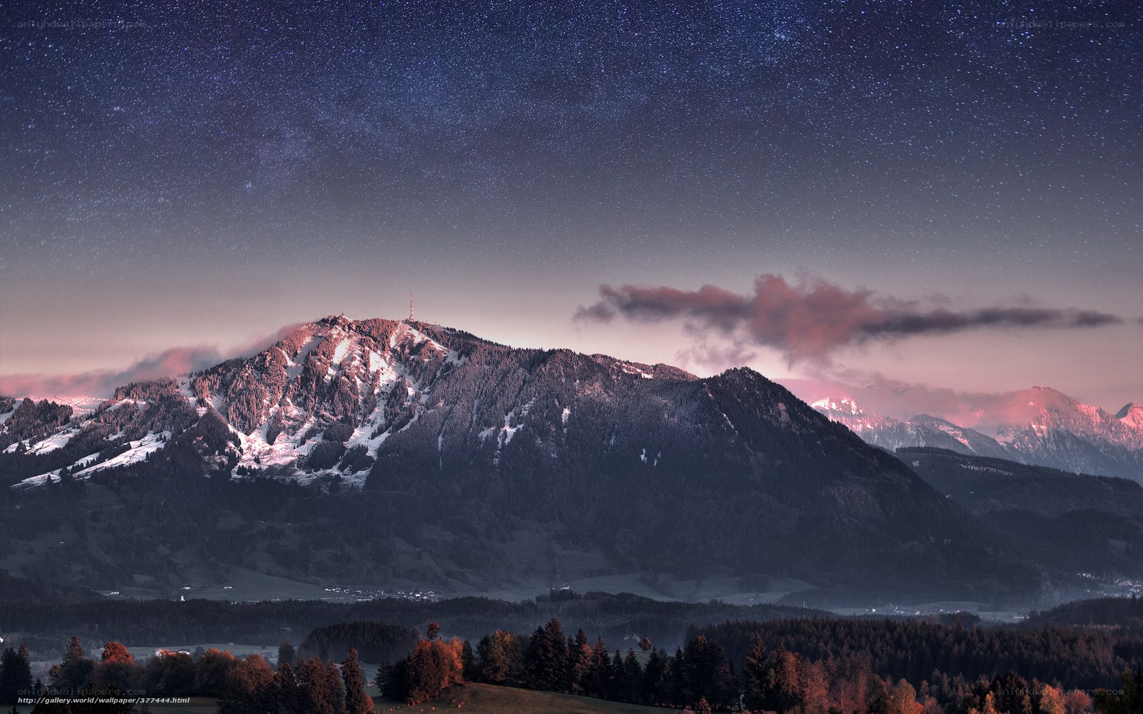 Starry night over snowy mountains
