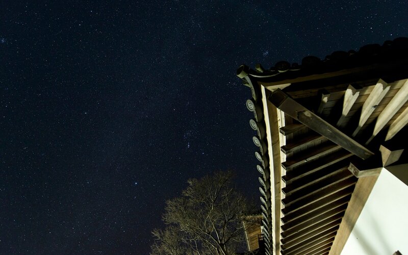 Starry night over traditional roof