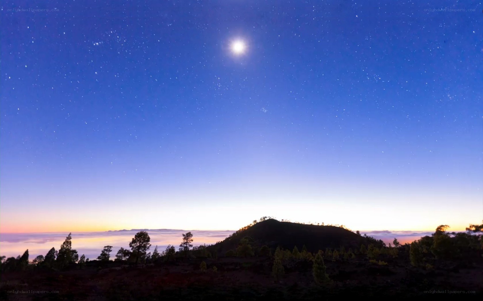 Starry night over volcanic hill