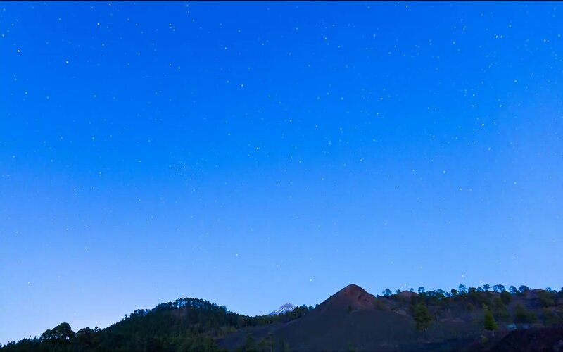 Starry night over volcanic hills