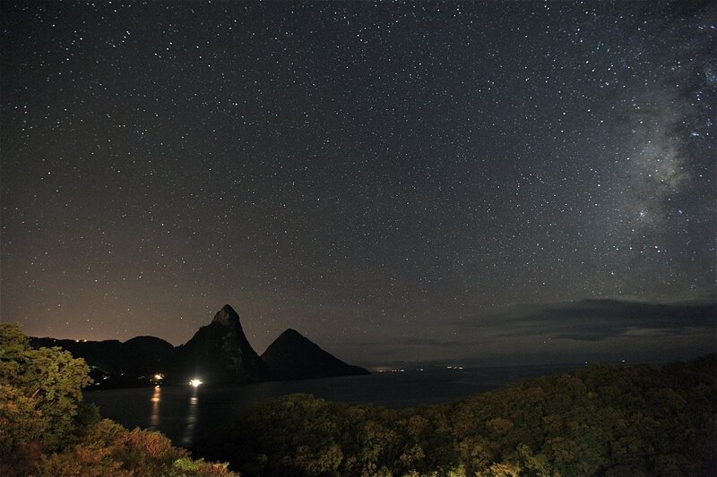 Starry night over volcanic peaks