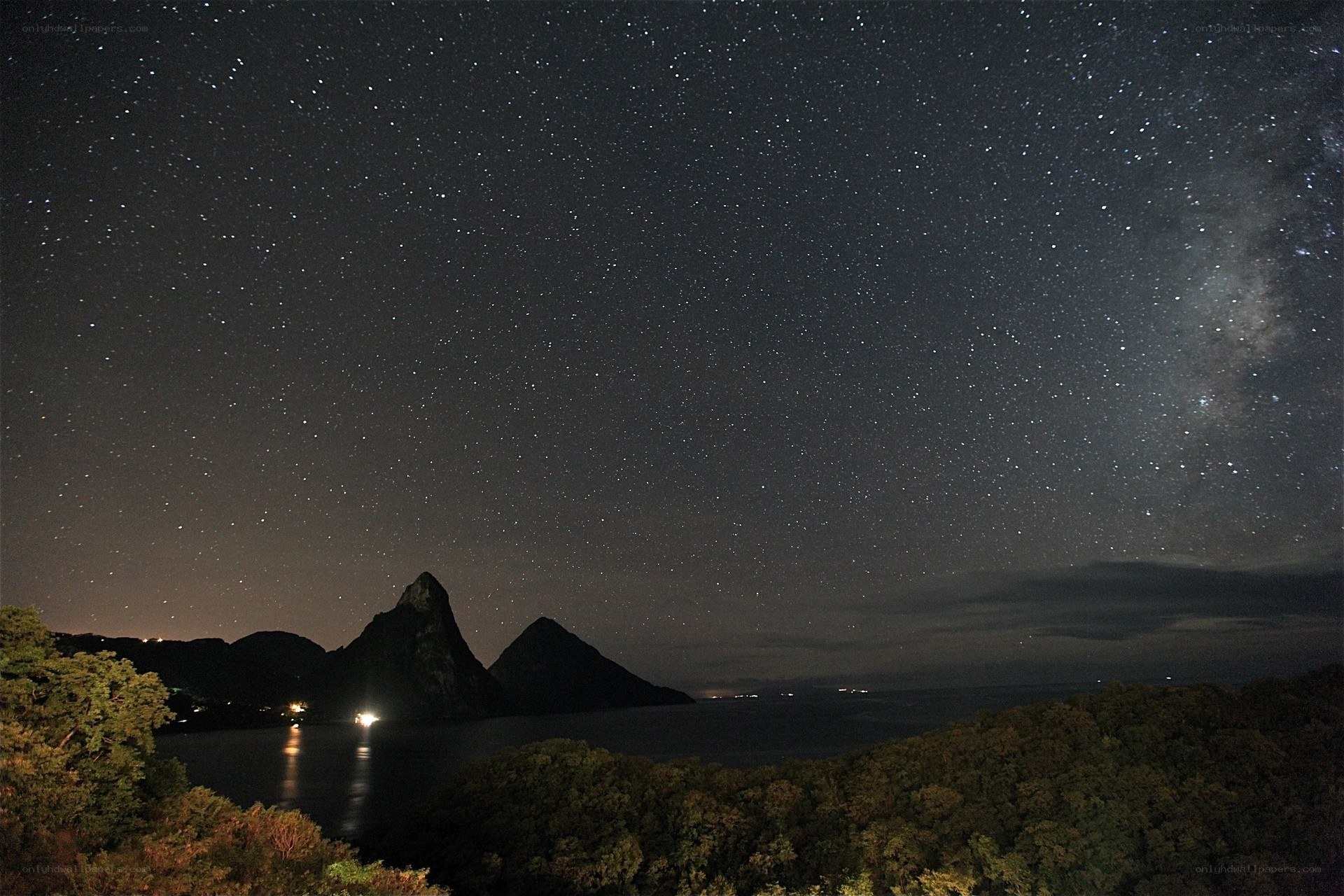 Starry night over volcanic peaks