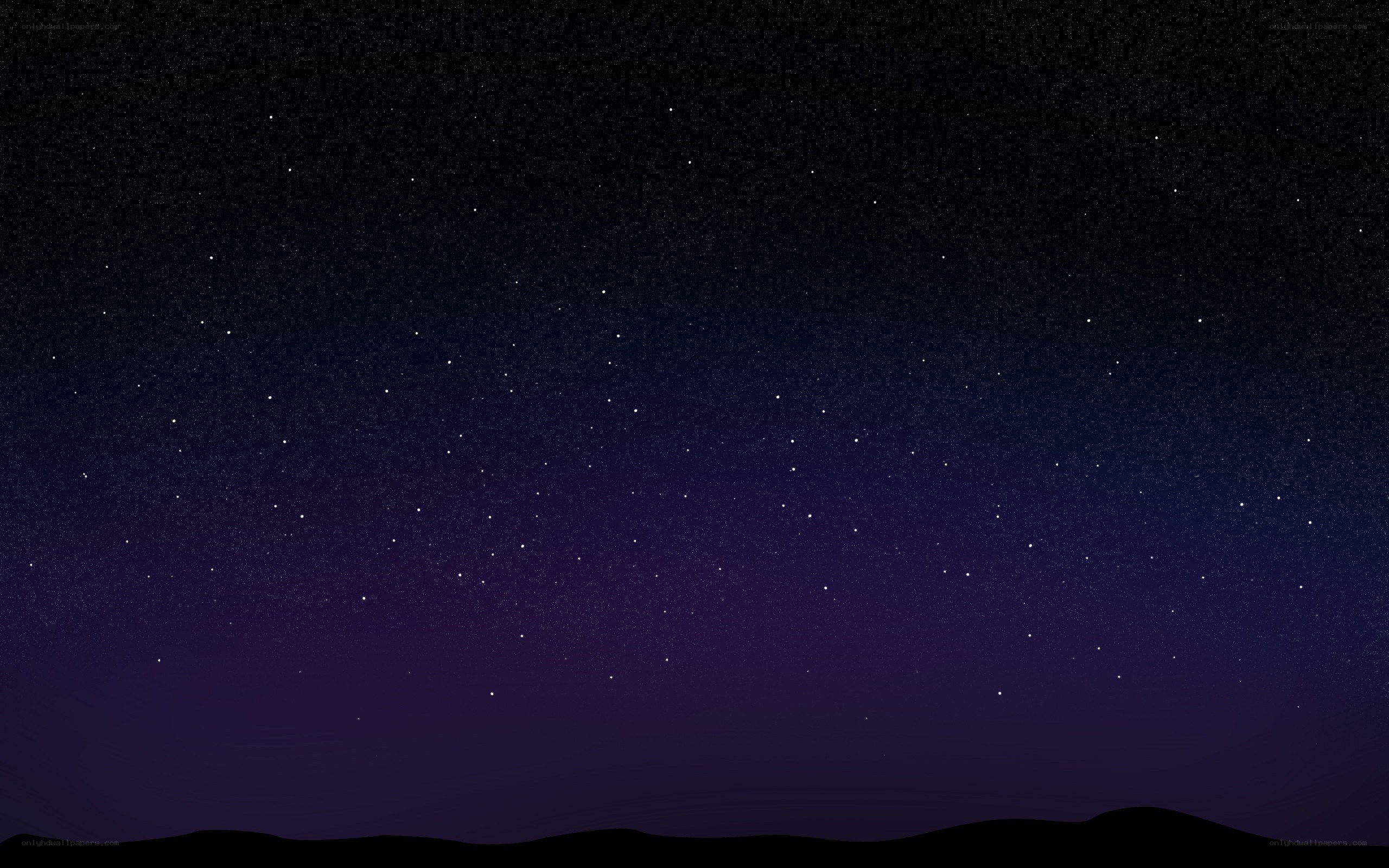 Starry night sky over hills