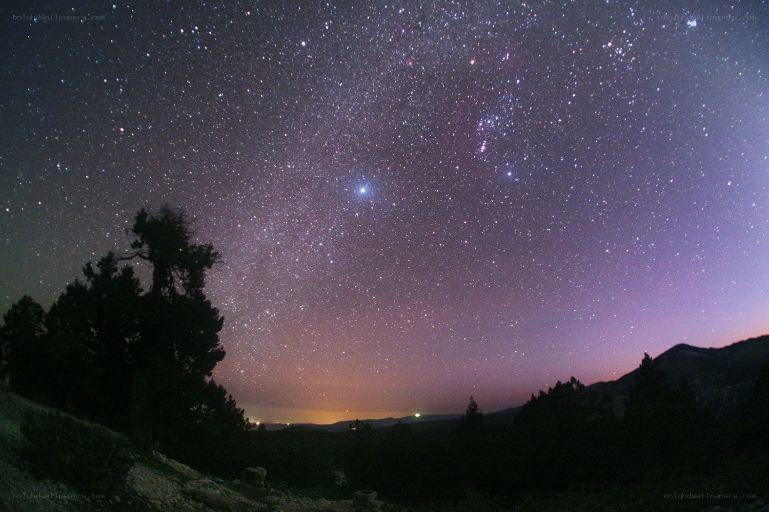 Starry night sky over mountains