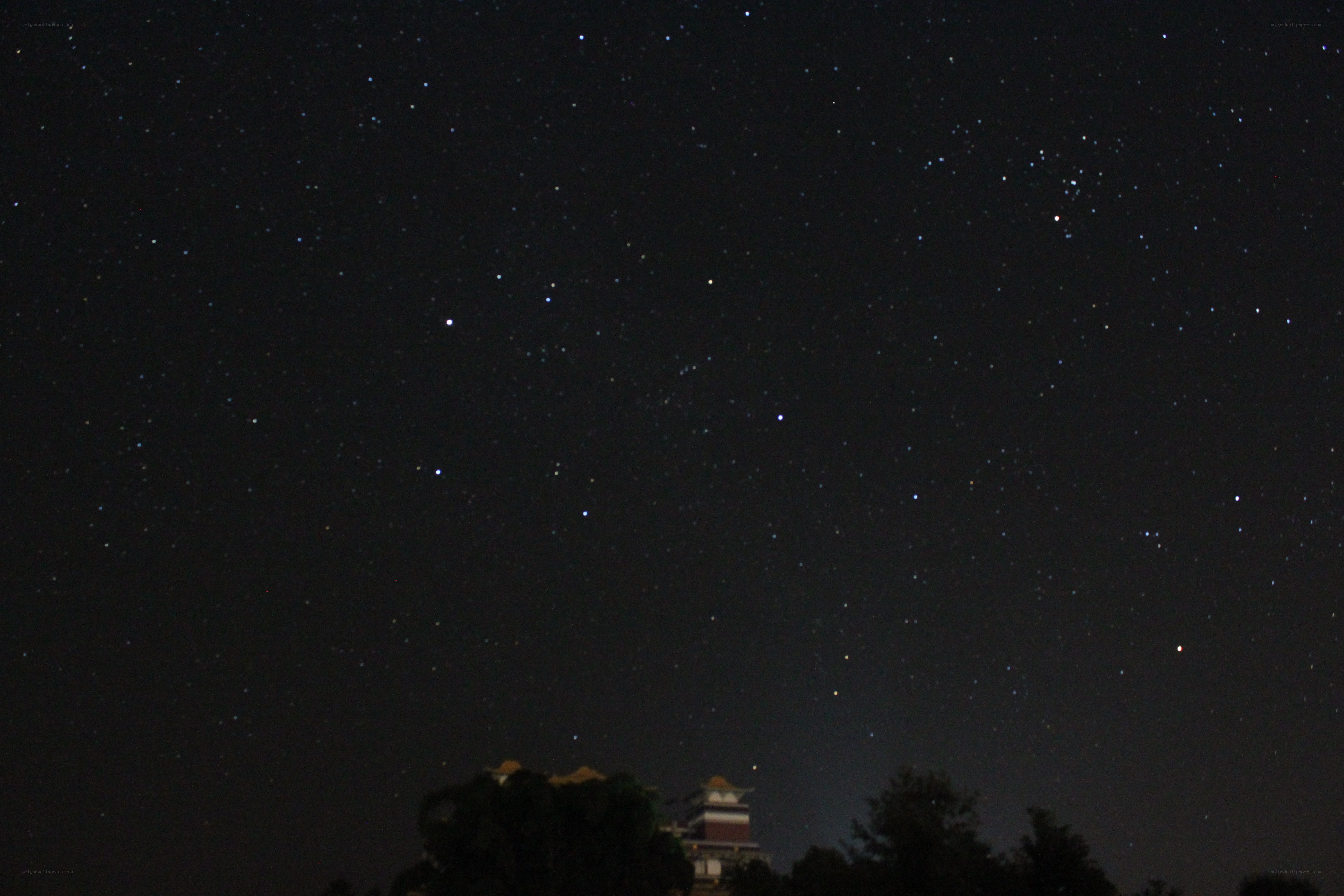Starry night sky over temple