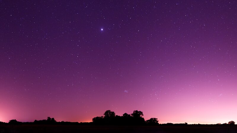 Starry night sky with purple hues