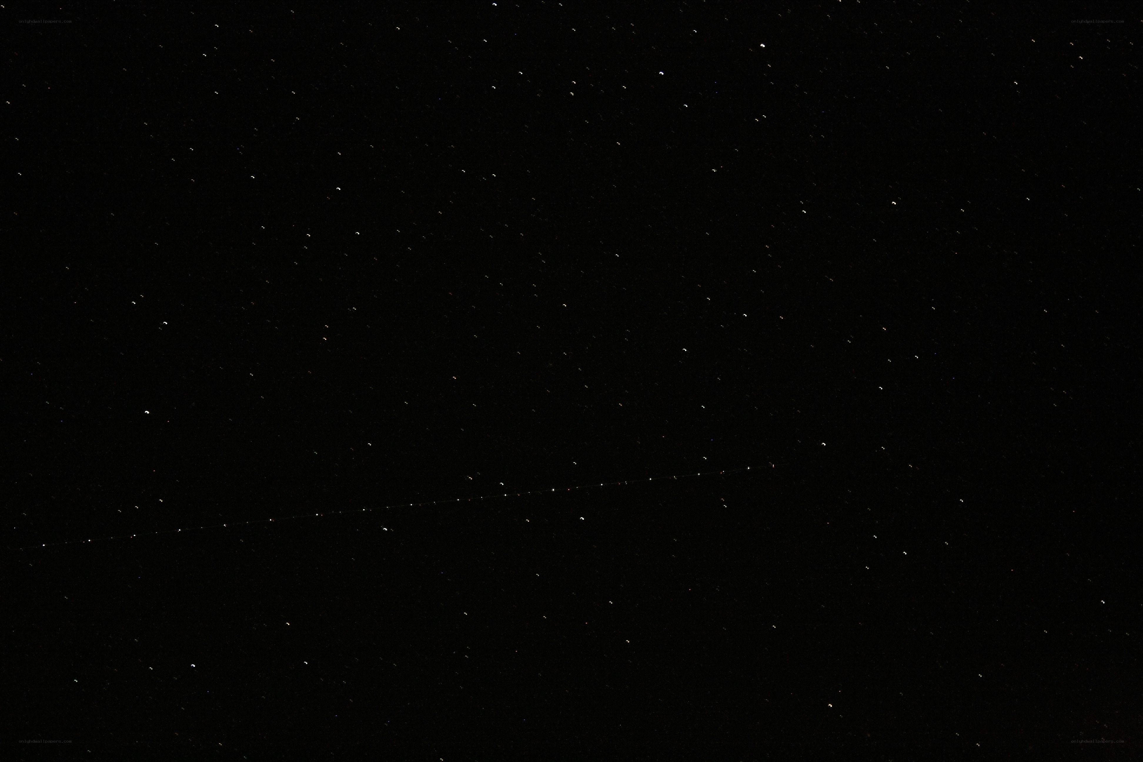 Starry night sky with satellite trail