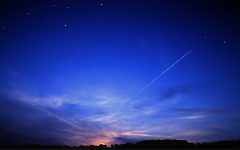 Starry night with contrails