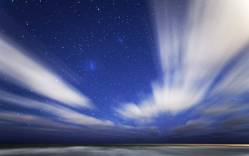 Starry night with moving clouds