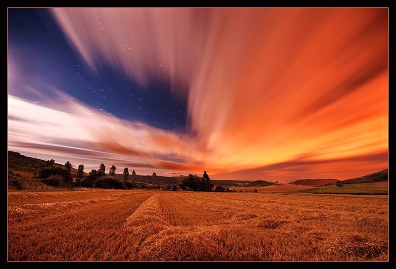 Starry sky over a harvested field