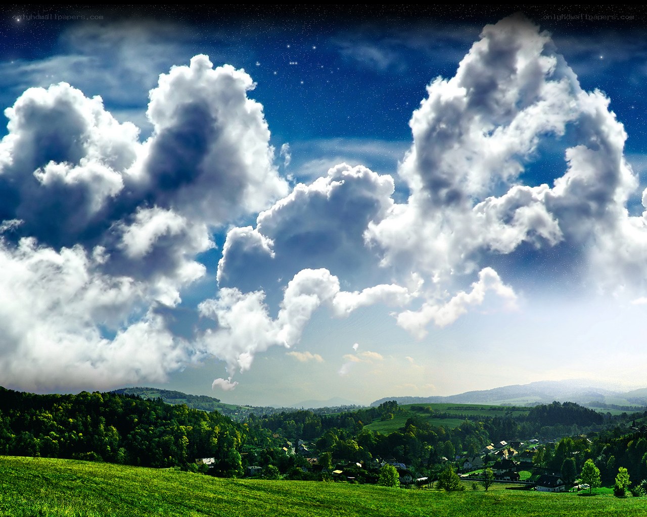 Starry sky over green hills