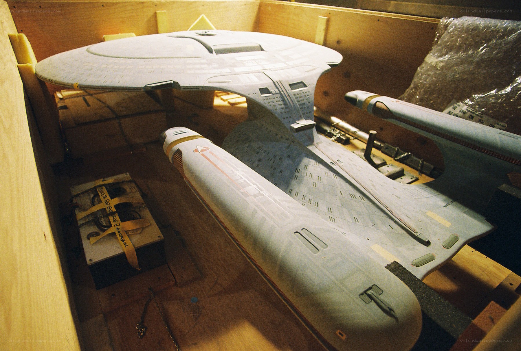 Starship model in wooden crate
