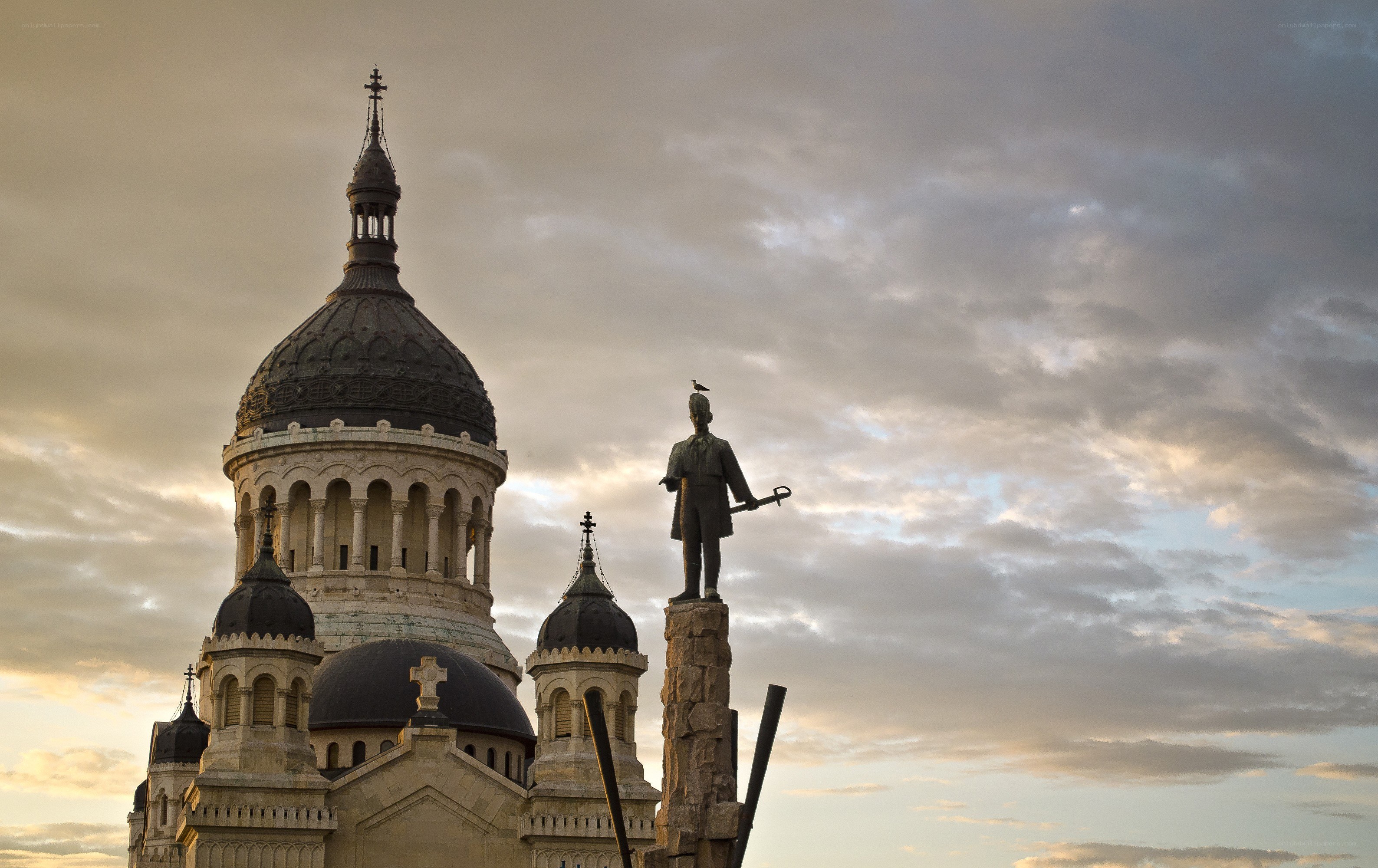 Statue and cathedral at dusk