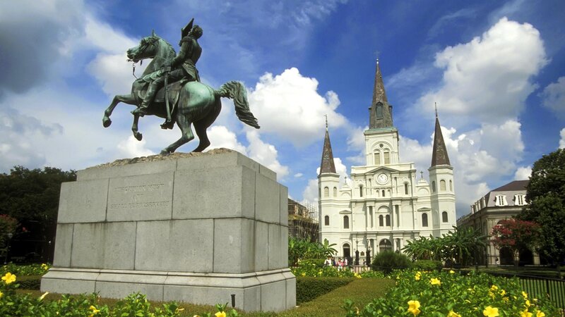statue and cathedral in new orleans
