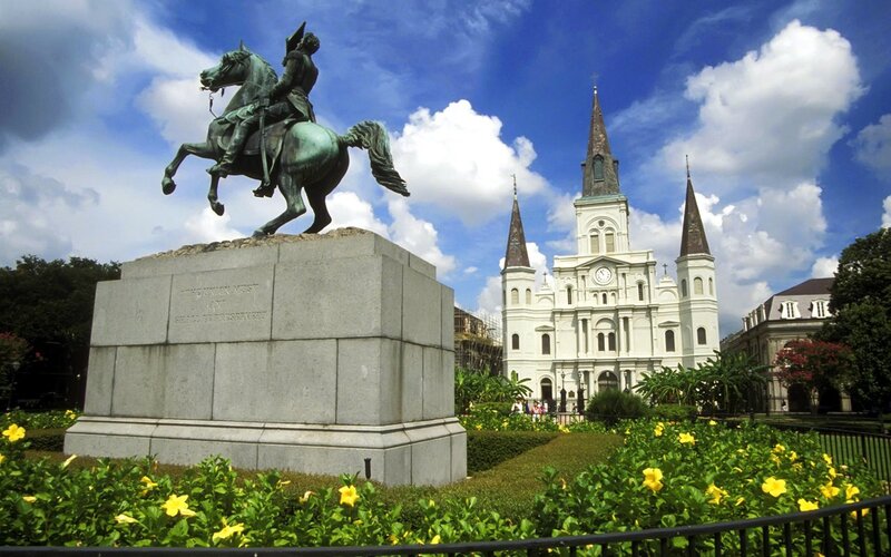 statue and cathedral in new orleans