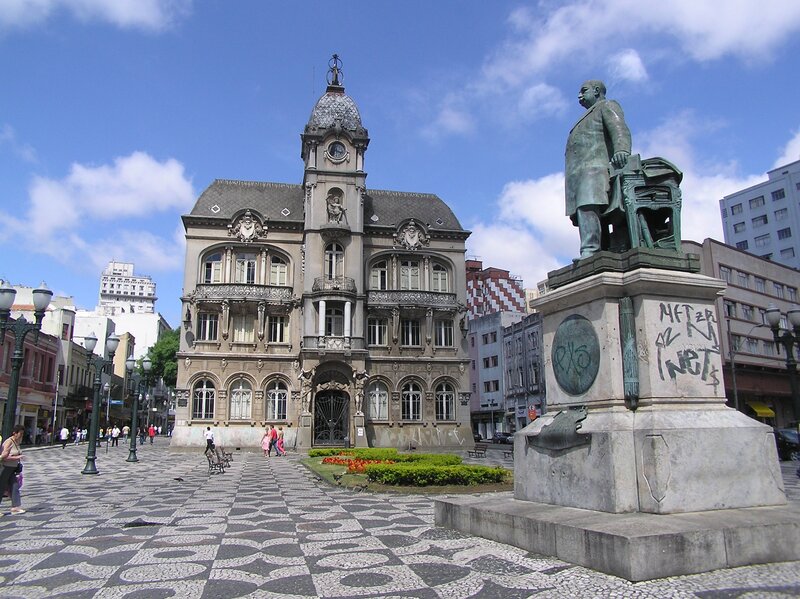 statue and historic building in plaza